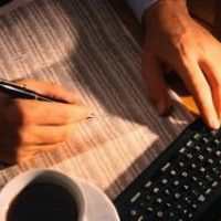 Businessman Looking over the Stock Page